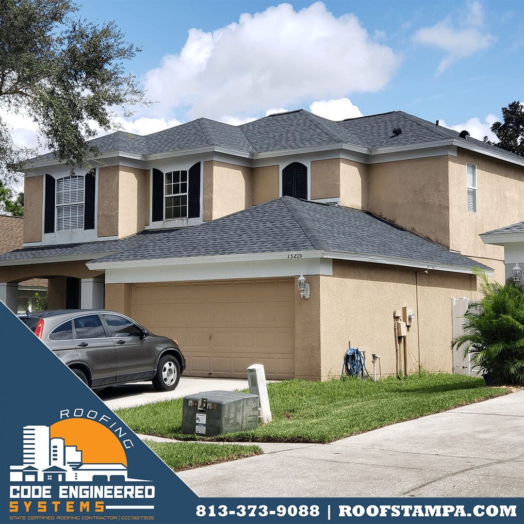 GAF Pewter Grey Shingles on a Beige House with White Drip Edge, & Black